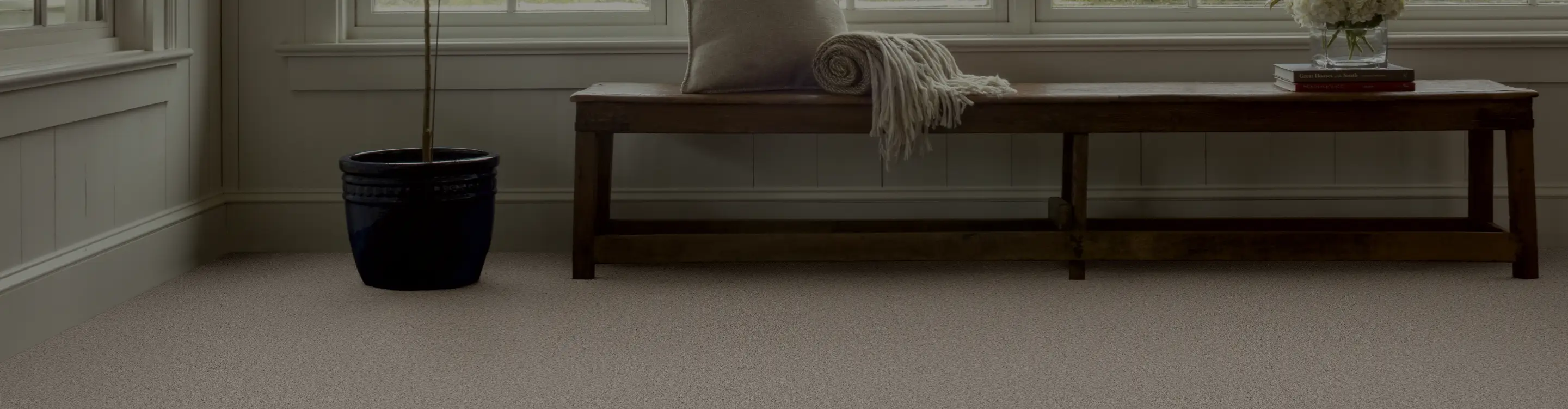 beige carpet in foyer with bench